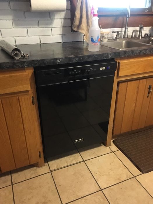 A kitchen with a black dishwasher