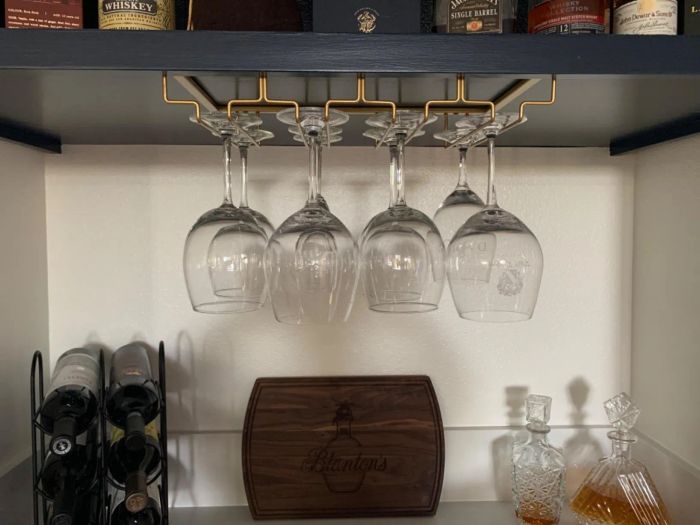 Reviewer's gold holder mounted under a shelf, neatly storing glasses