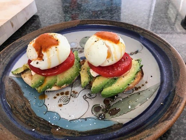 A reviewer's photo featuring poached eggs served on an English muffin