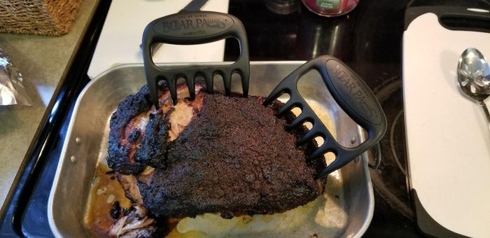 A reviewer photo showing the claws embedded in a large hunk of cooked pork