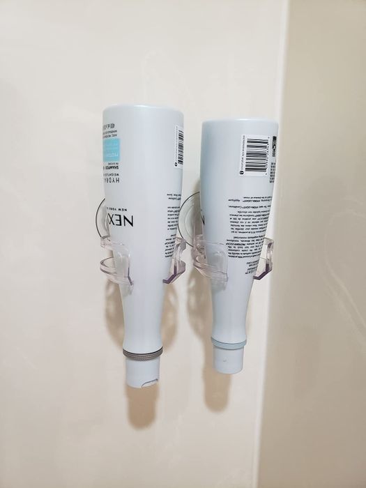 A reviewer’s photo showcasing two wine glass holders being used to store shampoo and conditioner bottles