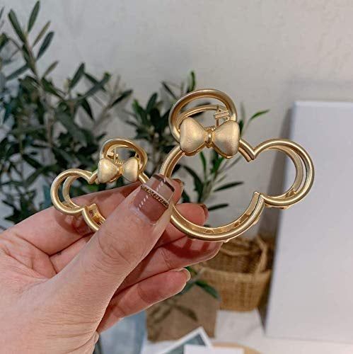 Two gold Minnie Mouse claw clips in varying sizes