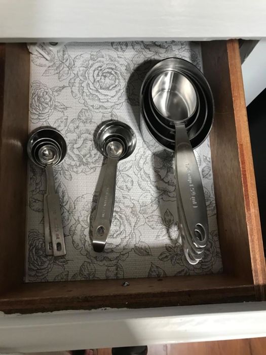 The interior of a reviewer's drawer, neatly lined with a grey-and-white floral patterned liner.