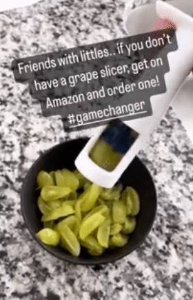 A gif showing the reviewer using the grape cutter to slice grapes into quarters, with a positive review quote displayed above.