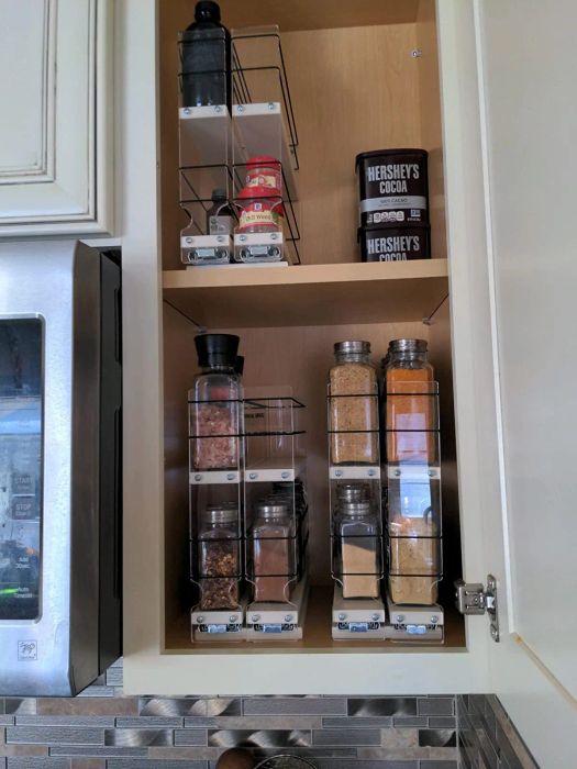 A reviewer shows a narrow cabinet with the vertical spice racks installed inside