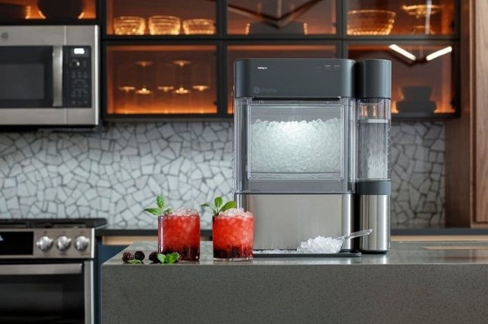 The ice maker sits on a kitchen counter, ready for use.