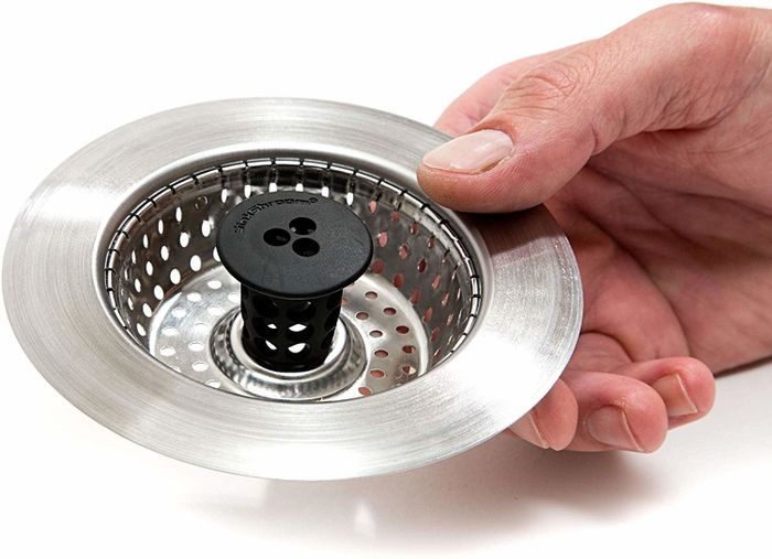 the stainless steel round strainer featuring a black rubber grip in the center