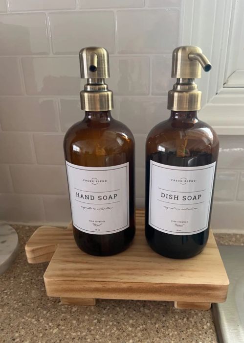 Two amber glass dispensers with labels