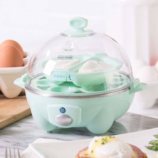 The green egg cooker with a transparent, domed lid
