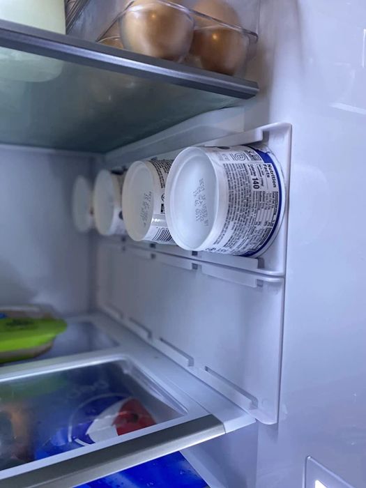 The reviewer's yogurt holder is neatly organized in their fridge.