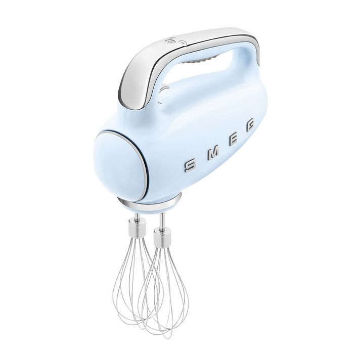 A light blue SMEG hand mixer with dual whisk attachments, showcasing its sleek, modern aesthetic