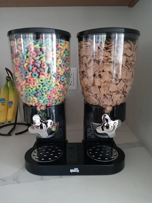 A reviewer's image of the black cereal dispenser holding two different types of cereal.