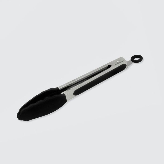 Metal kitchen tongs with black silicone handles against a light backdrop