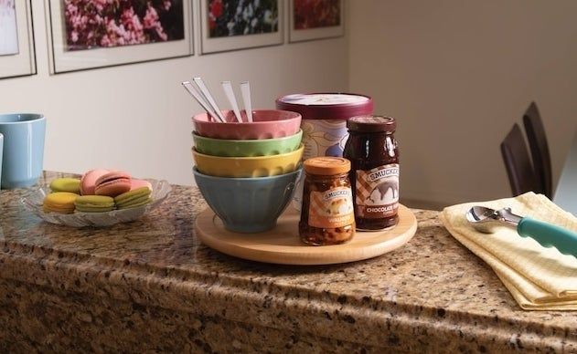 Bowls, utensils, and jars neatly arranged on a Lazy Susan.
