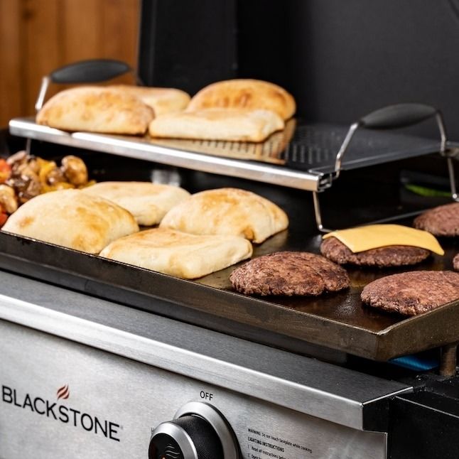 A metal warming rack displayed on a grill