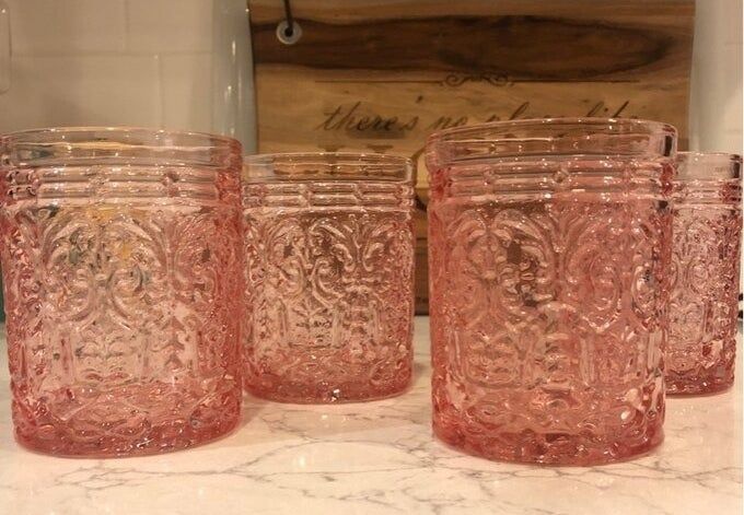 An image of four colorful drinking glasses placed on a kitchen counter.