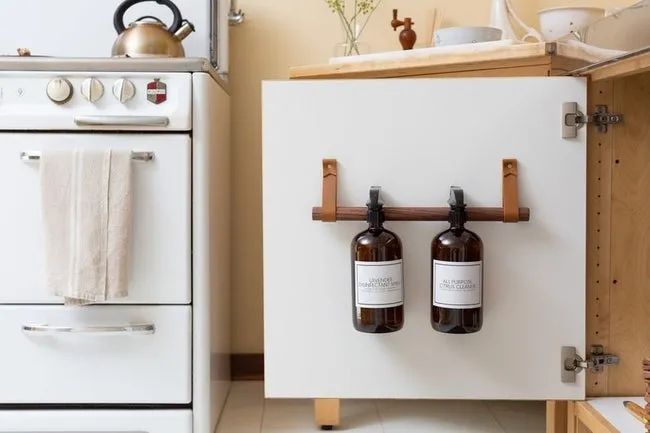 open kitchen cabinet featuring a storage rail inside the cabinet door