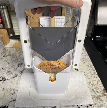 A bagel placed under the 'guillotine' for slicing