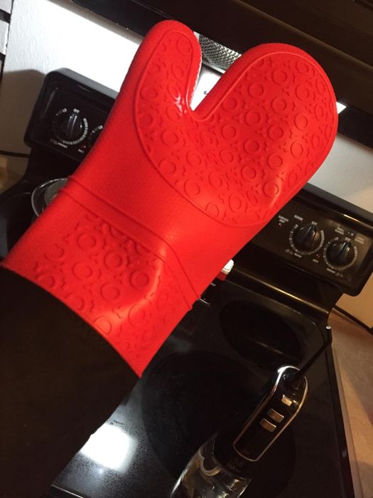 A red, extra-long oven mitt
