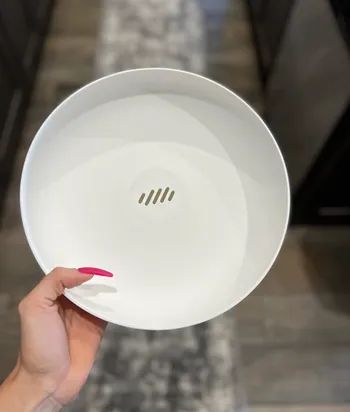 A close-up showing the subtle slits in the fruit bowl that allow water to drain away.