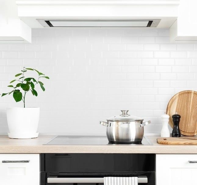 A white peel-and-stick backsplash on a kitchen wall