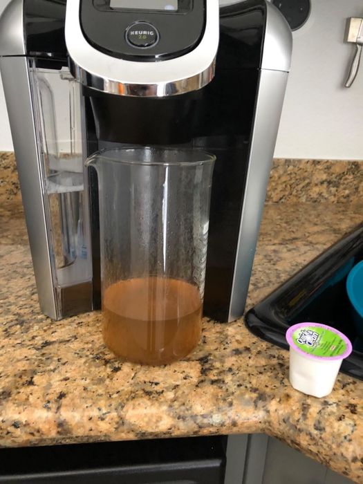 A reviewer's photo of coffee residue in water after using the Quick and Clean K-Cup