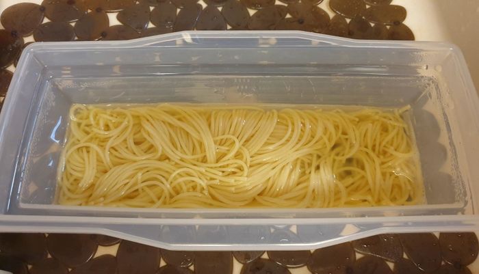 A photo from the same reviewer showing perfectly cooked pasta and water in the clear, plastic microwave pasta cooker