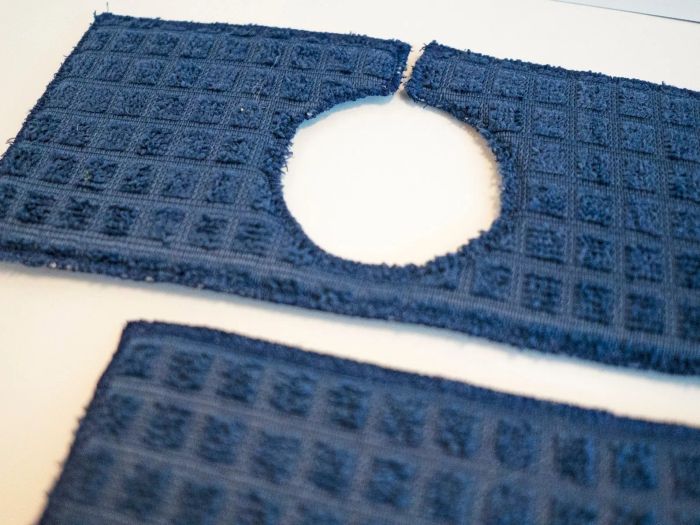 A closeup of a navy blue sink drip guard, neatly positioned around the faucet.