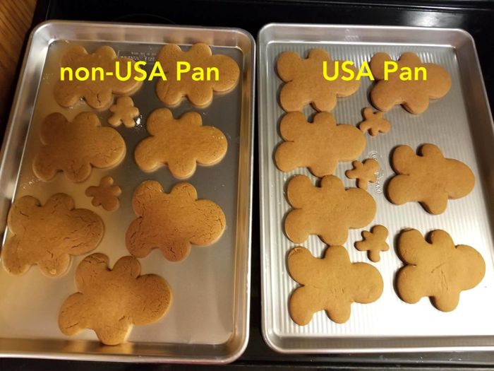 A reviewer baking gingerbread cookies on two different pans. The USA Pan (right) produced smooth cookies, while the left pan made cracked ones.