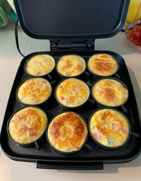 Nine round egg bites cooked in a small grill