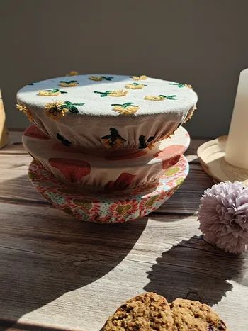 Three bowls stacked, each adorned with a different floral cover