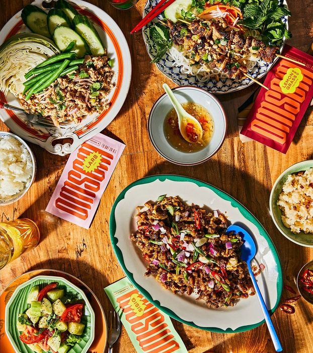 A table stacked with noodle boxes and sauce packets