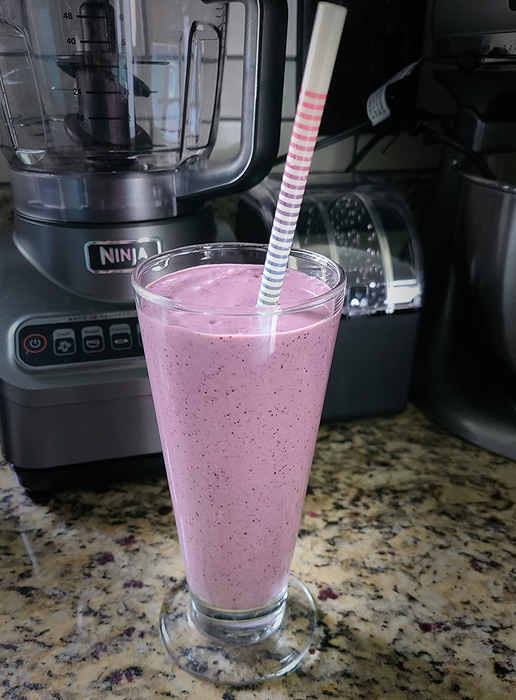 A reviewer’s photo of a vibrant purple smoothie made in the Ninja