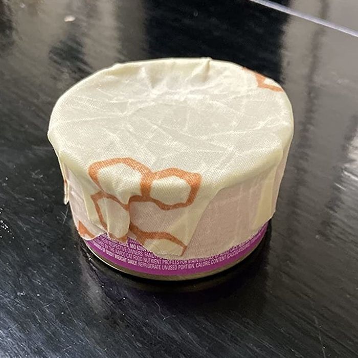 A reviewer’s photo showing a can with a beeswax wrap covering the top