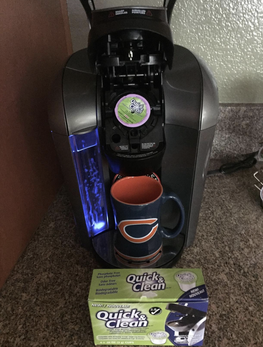 Reviewer photo showing the Keurig machine with a cleaning K-cup inside