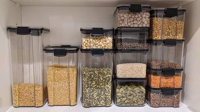 A reviewer's photo of various sized containers filled with dry goods neatly organized on a shelf
