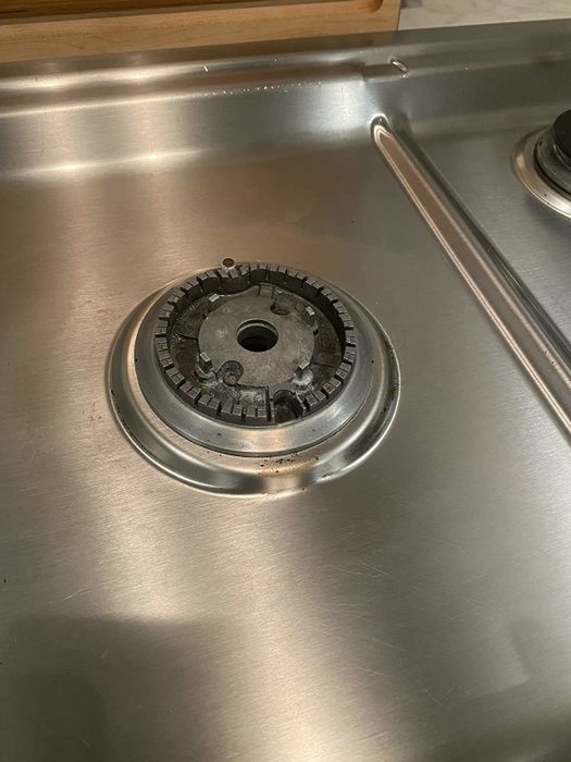 A reviewer’s photo showing a clean gas range burner after using the cleaner