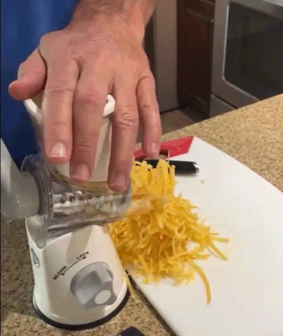 a reviewer demonstrating how effortlessly cheese can be grated