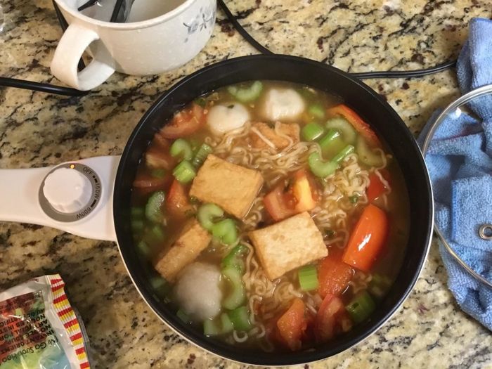 Reviewer's hot pot filled with veggies and noodles