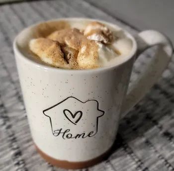 Cinnadust sprinkled on top of creamy coffee