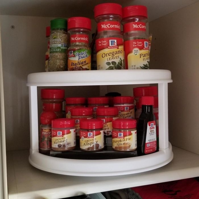 Reviewer's photo shows a turntable filled with spices in a cabinet