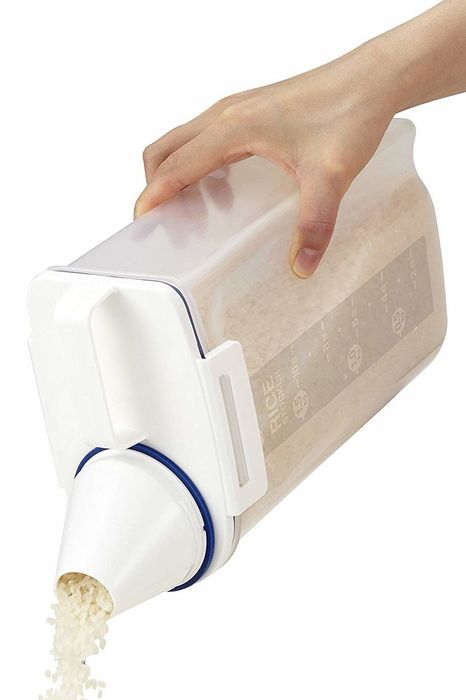 Rice-filled storage bin being emptied through the spout