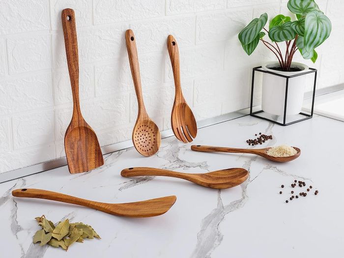 The wooden utensil set on a kitchen counter