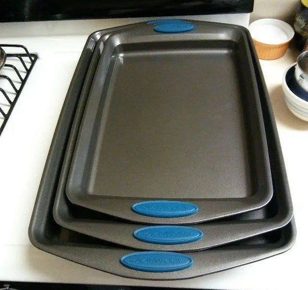 reviewer image of the trio of baking sheets on a kitchen counter