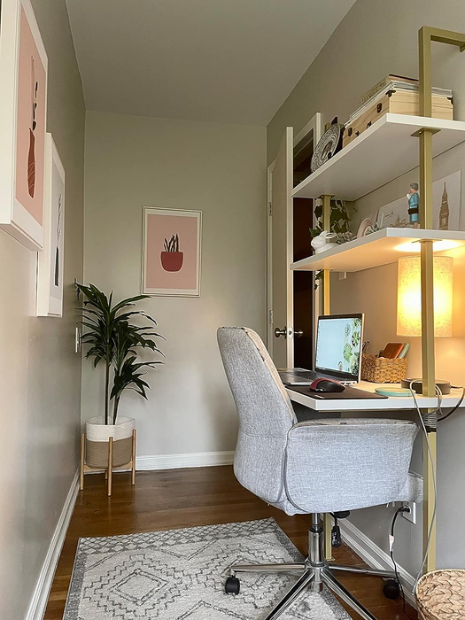 another reviewer's white and gold desk in a compact office space
