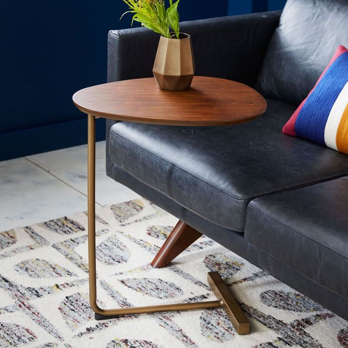 the walnut side table placed beside the couch
