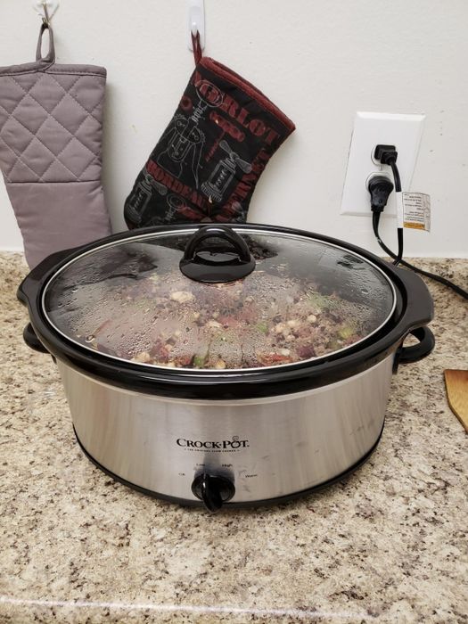 The Crock-Pot simmering food on a kitchen countertop