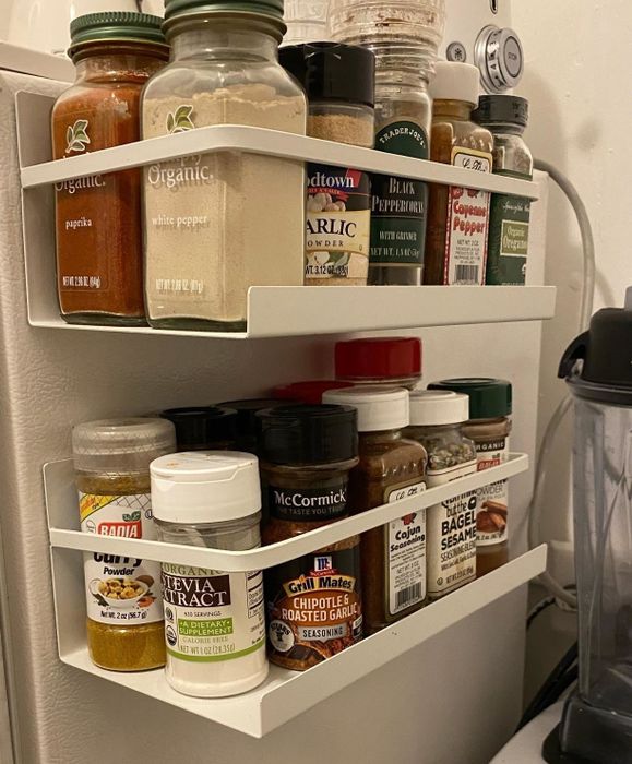 Reviewer's magnetic shelf is shown mounted on the side of a fridge