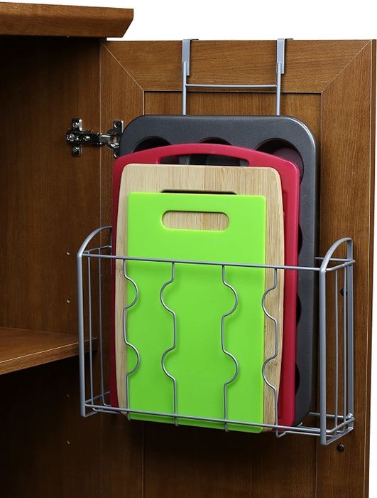 An over-the-door storage shelf hanging inside a cabinet door