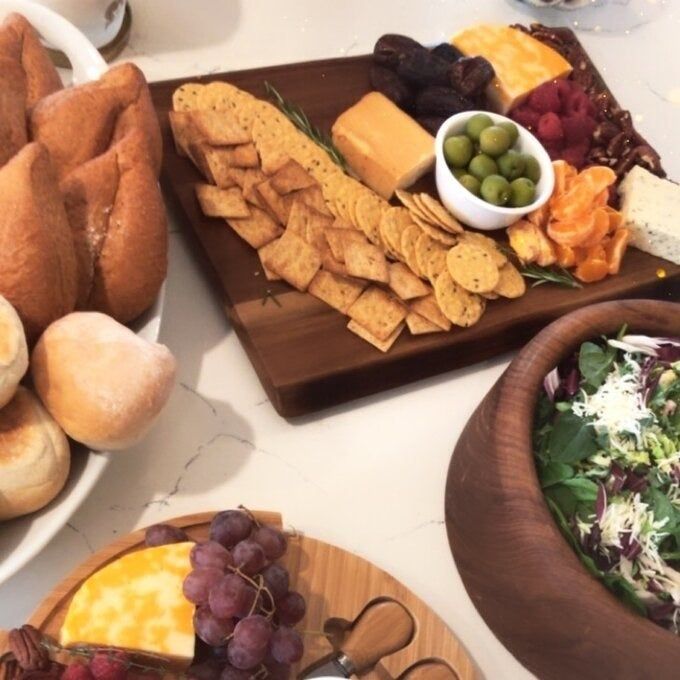 the cutting board with crackers arranged on it